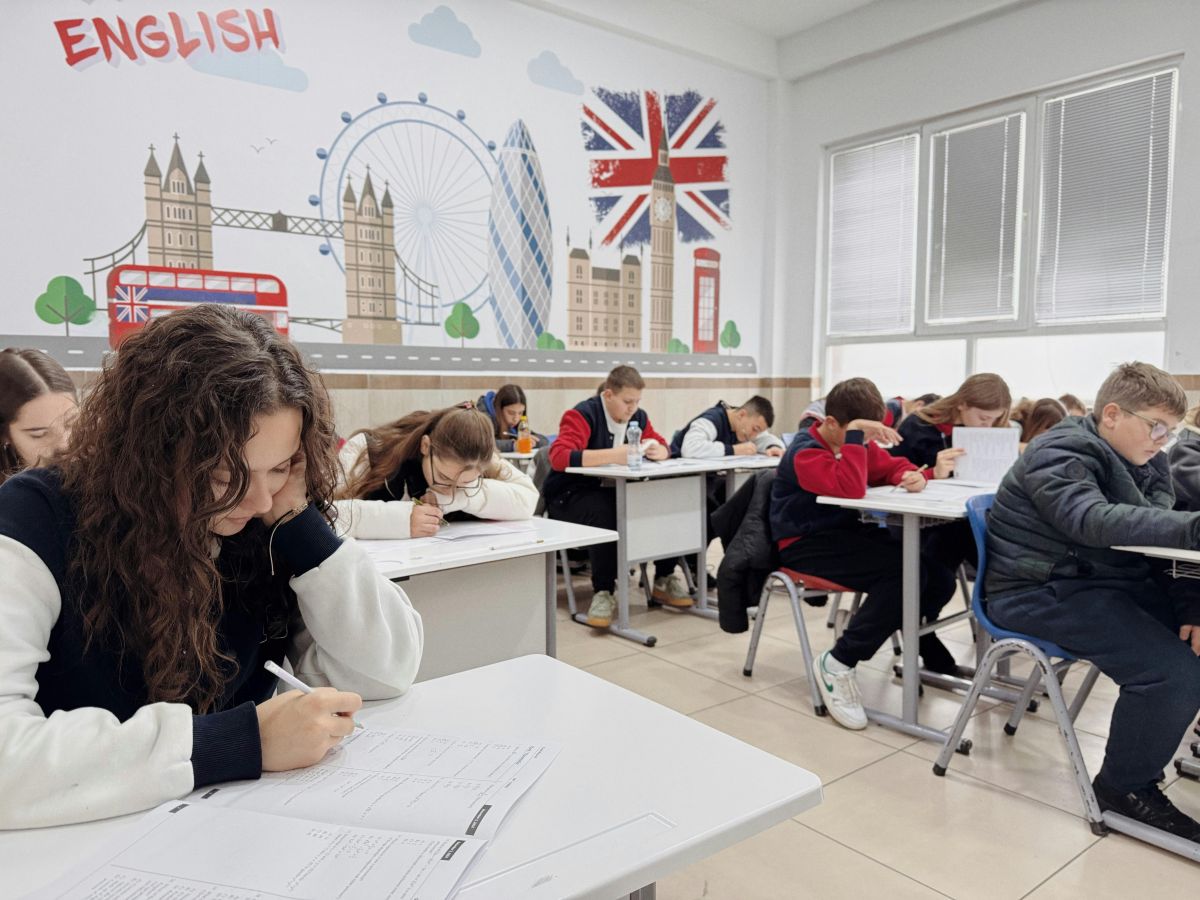 A classroom decorated with UK motifs, full of students in uniform, who are probably EFL students.